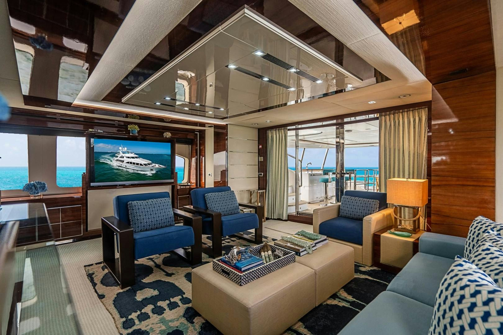 a living room with a large screen aboard No Name Yacht for Sale