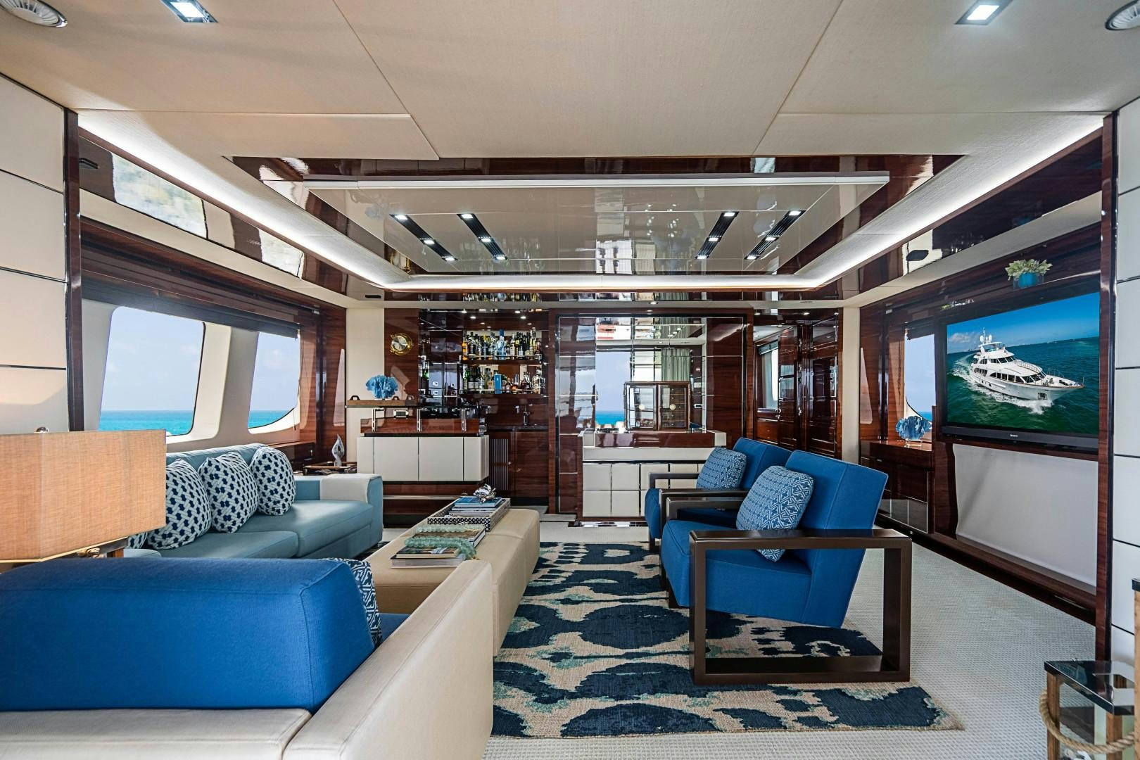 a living room with a blue couch aboard No Name Yacht for Sale