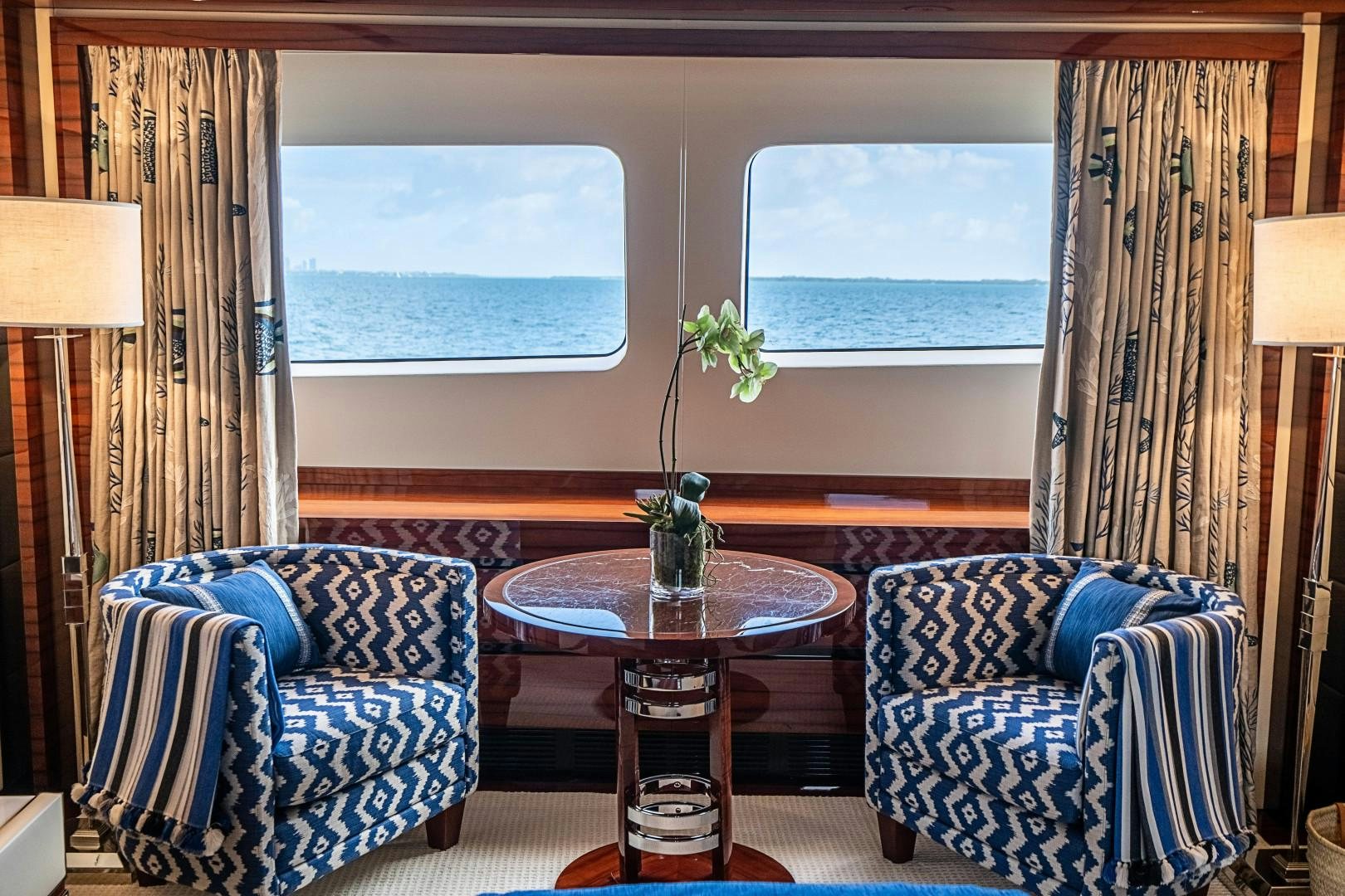a living room with a table and chairs aboard No Name Yacht for Sale
