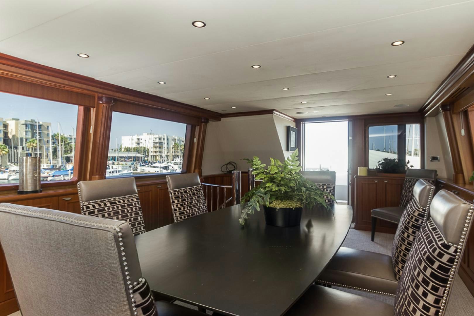 a large room with a table and chairs aboard LIQUIDITY Yacht for Sale