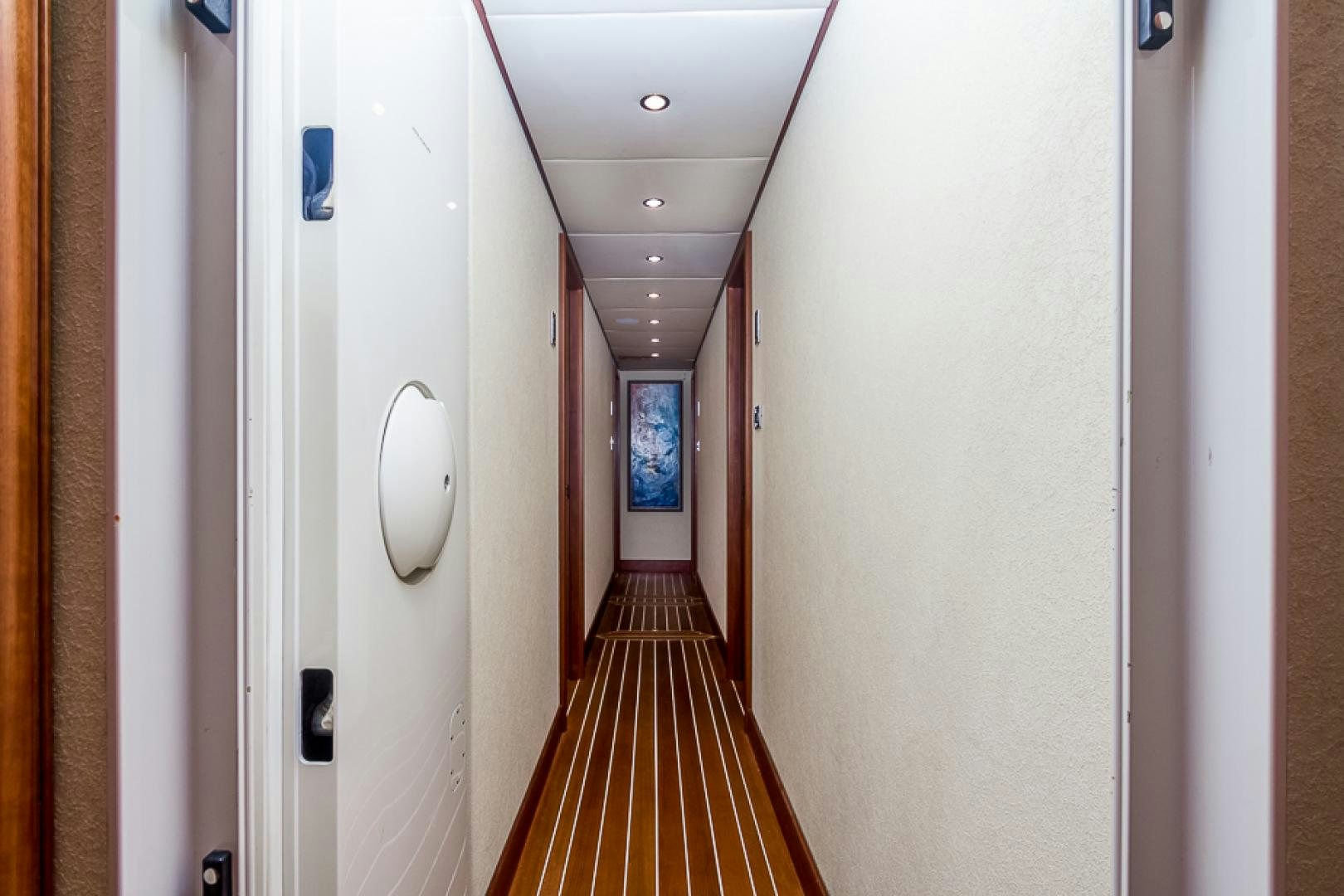 a hallway with doors aboard LIQUIDITY Yacht for Sale