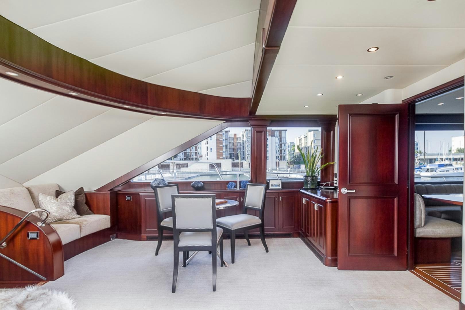 a room with a table chairs and a couch aboard LIQUIDITY Yacht for Sale