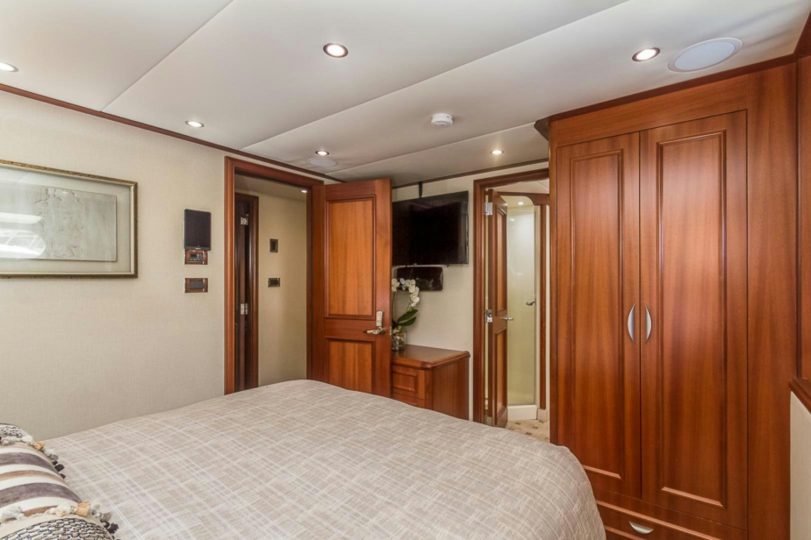 a bedroom with a bed and cabinets aboard LIQUIDITY Yacht for Sale