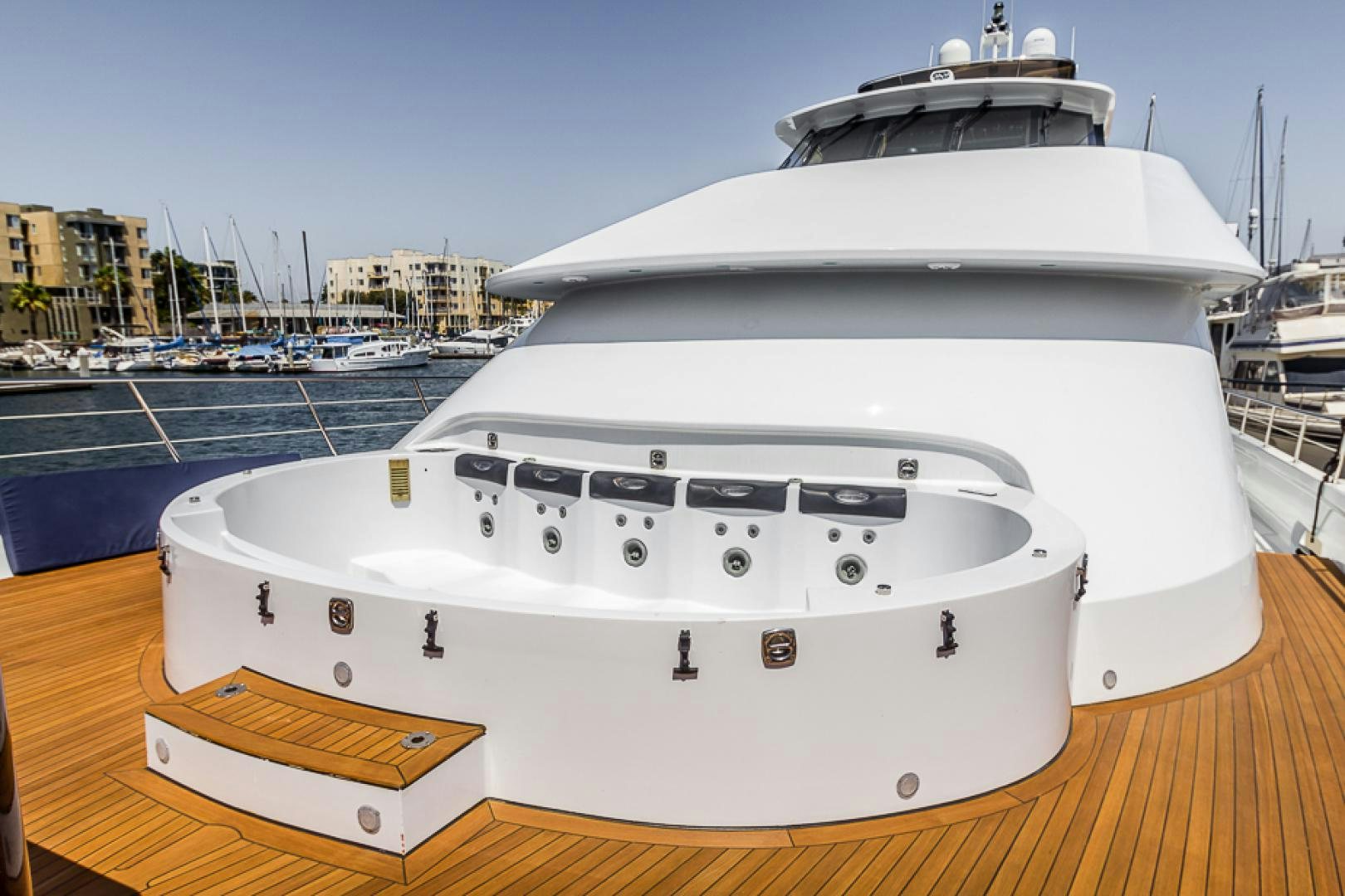 a white yacht on a dock aboard LIQUIDITY Yacht for Sale