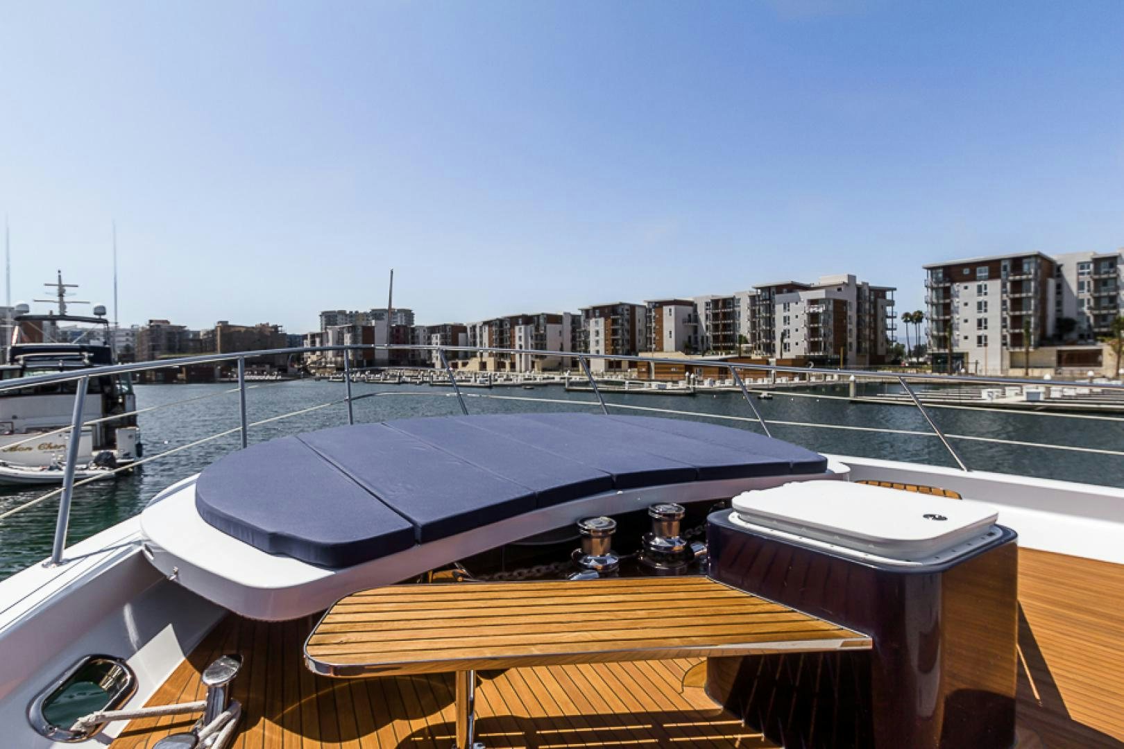 a deck with a table and a view of a city aboard LIQUIDITY Yacht for Sale