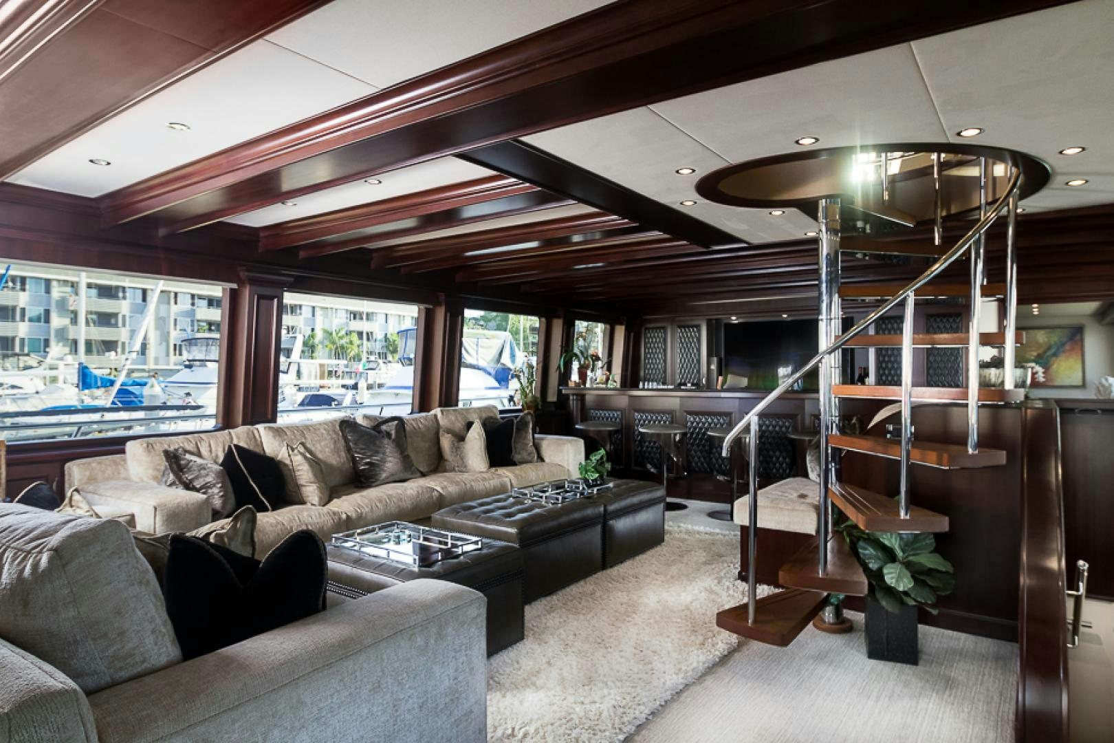 a living room with a ladder aboard LIQUIDITY Yacht for Sale