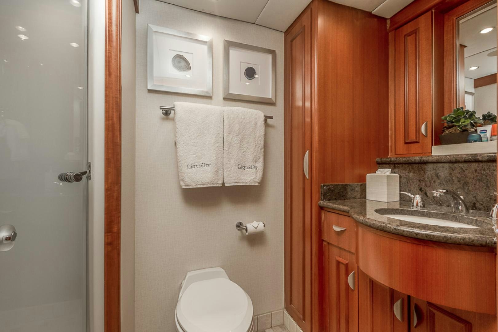 a bathroom with a toilet and sink aboard LIQUIDITY Yacht for Sale