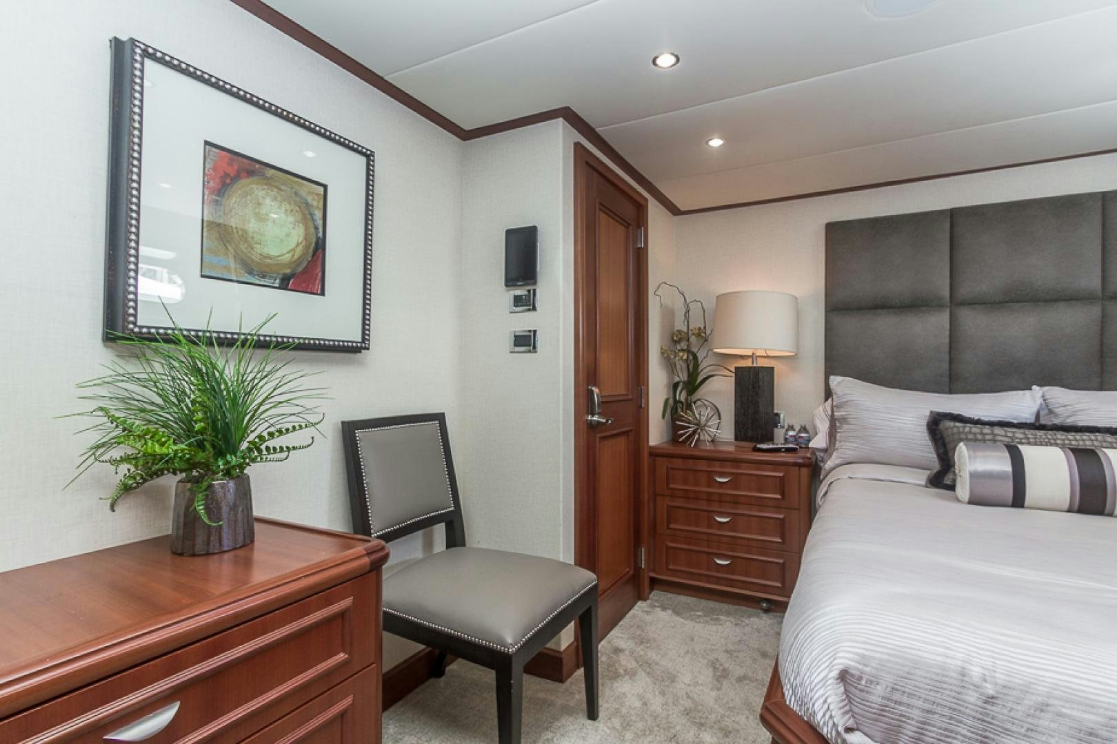 a bedroom with a bed and a desk aboard LIQUIDITY Yacht for Sale