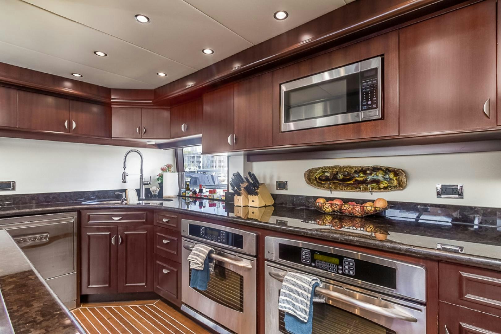 a kitchen with wooden cabinets aboard LIQUIDITY Yacht for Sale