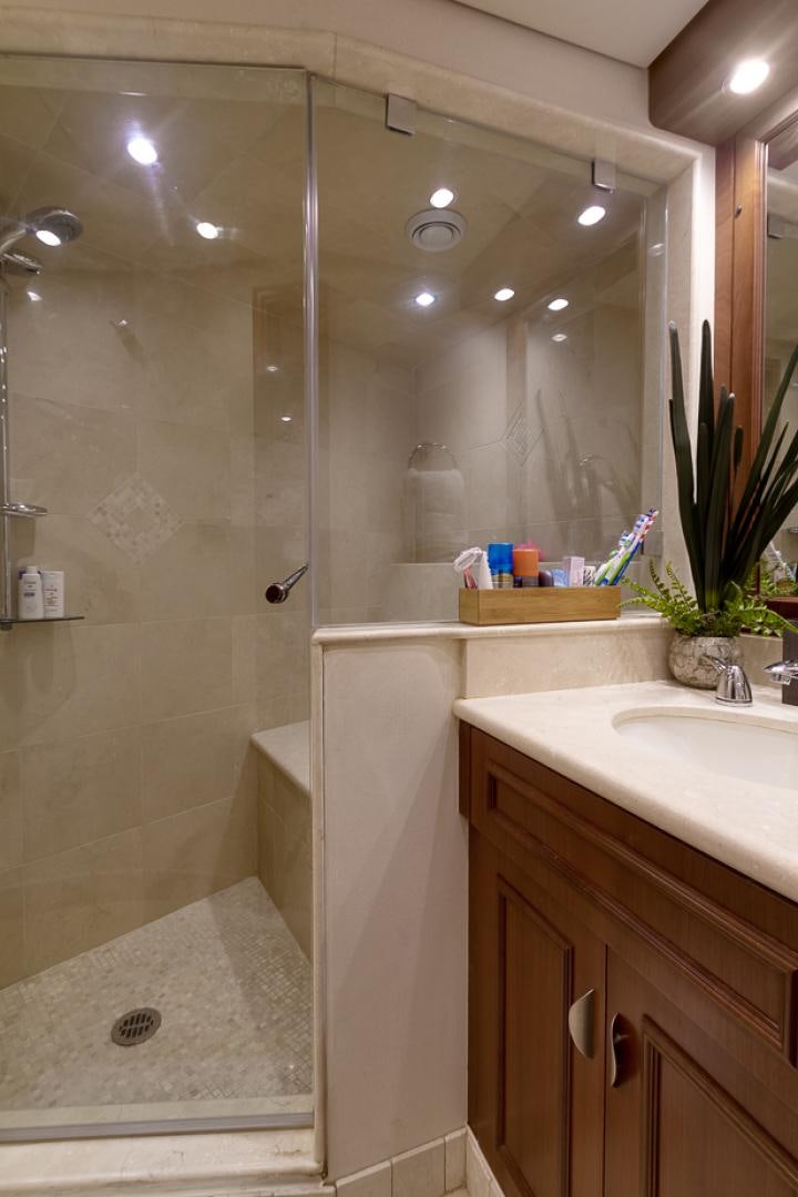 a bathroom with a shower and sink aboard LIQUIDITY Yacht for Sale