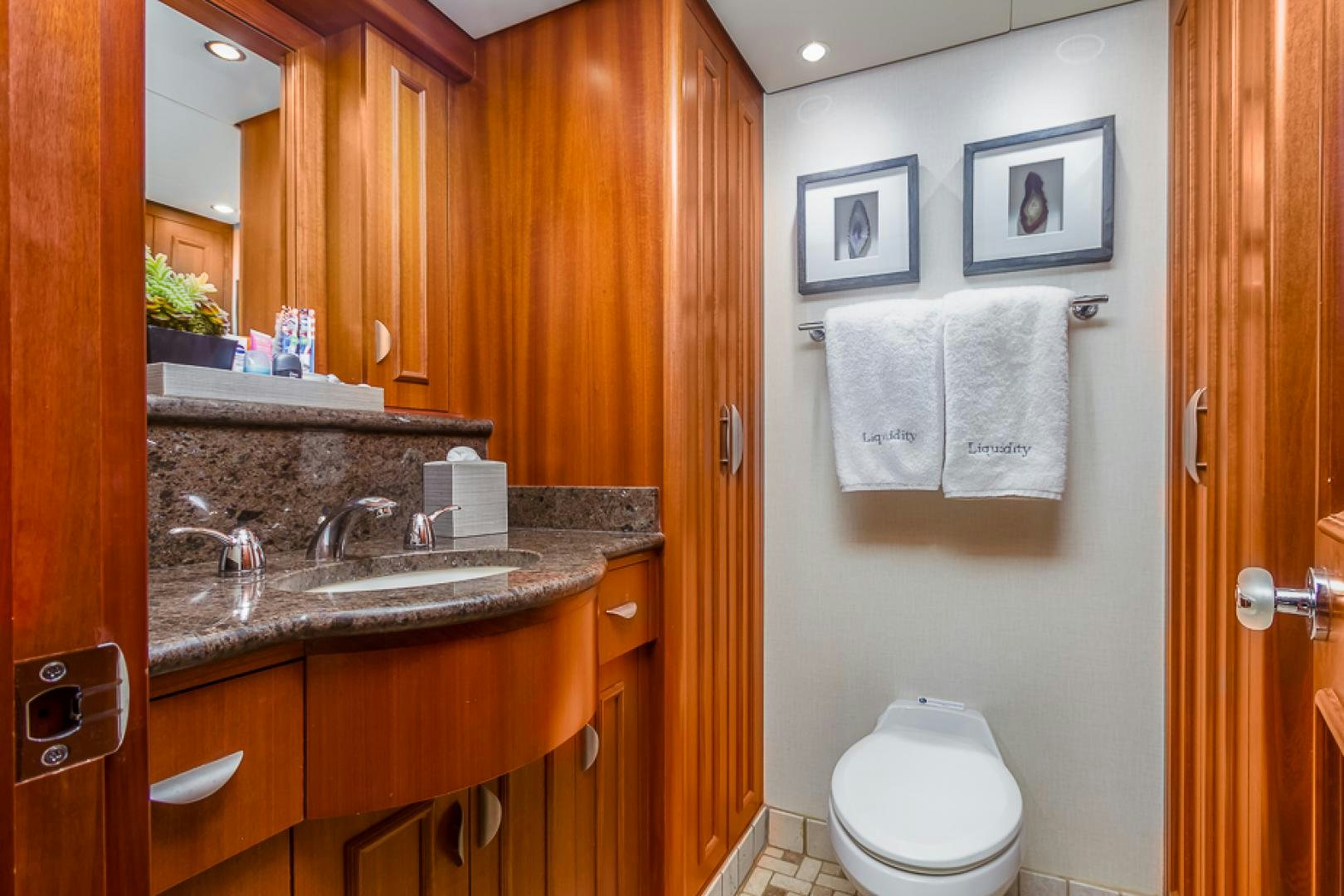 a bathroom with a toilet and sink aboard LIQUIDITY Yacht for Sale