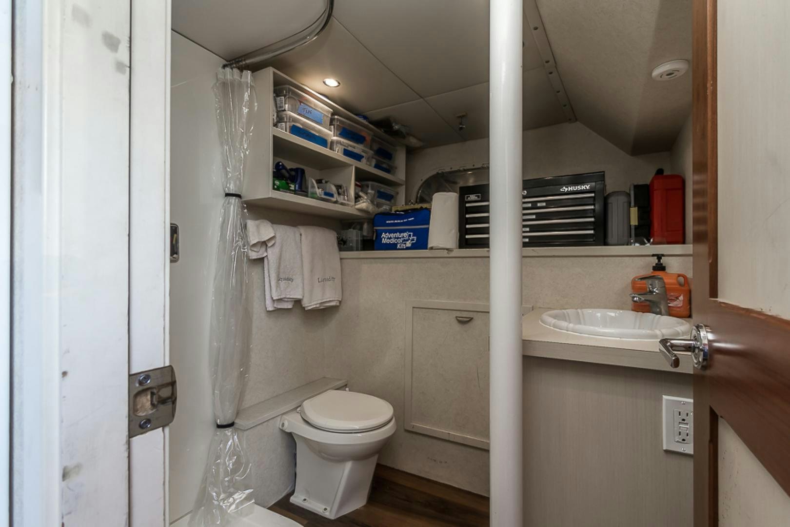 a bathroom with a toilet sink and a shower unit aboard LIQUIDITY Yacht for Sale