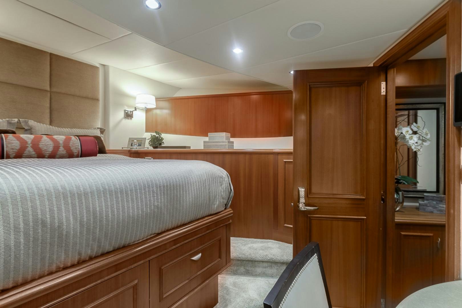 a bedroom with a bed and a mirror aboard LIQUIDITY Yacht for Sale
