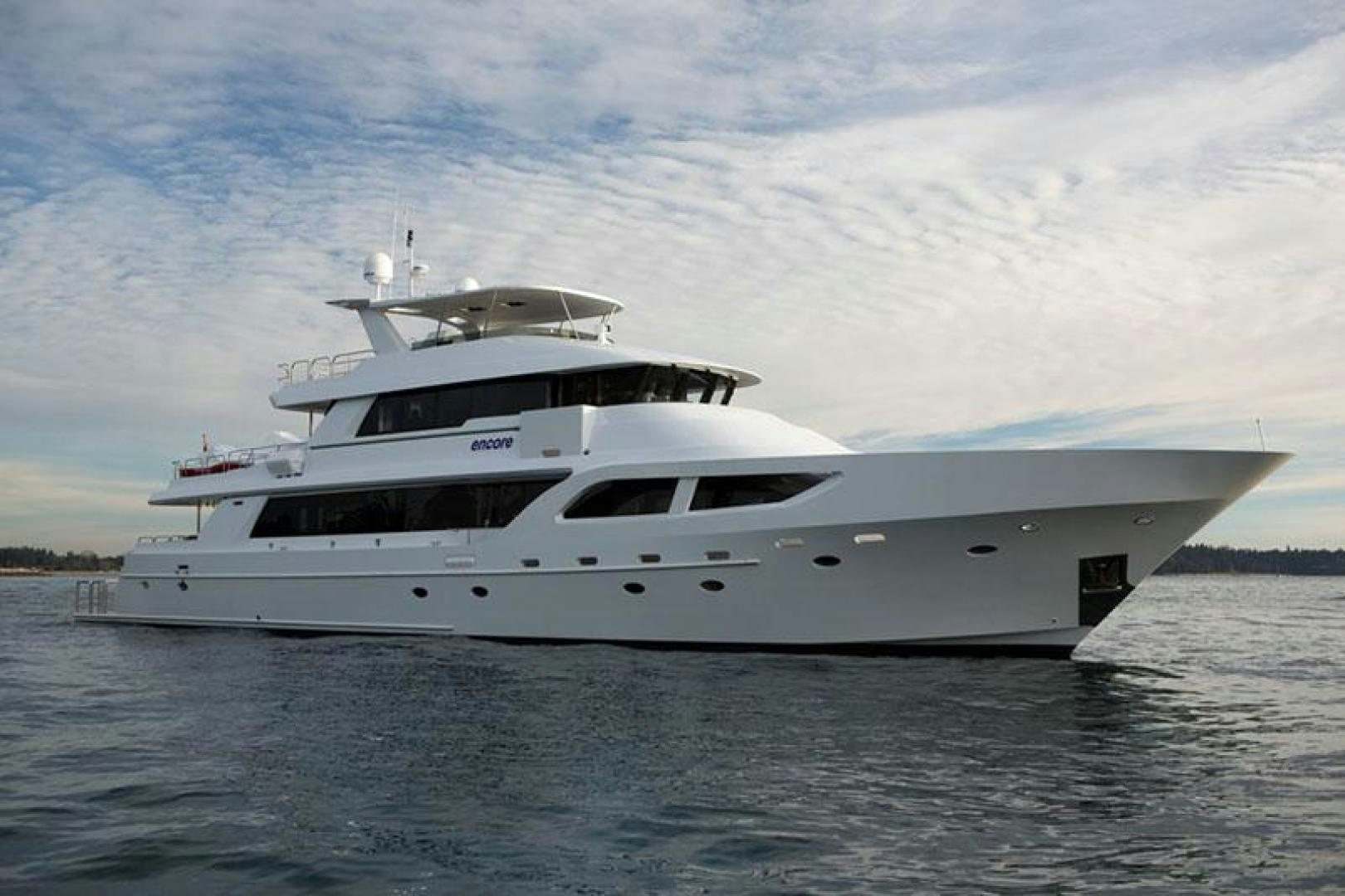 a white yacht on the water aboard ENCORE Yacht for Sale