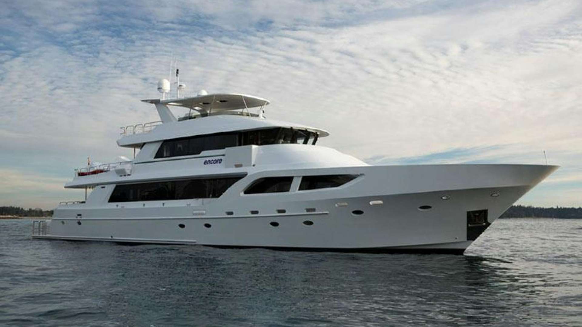 a white yacht on the water aboard Encore Yacht for Sale