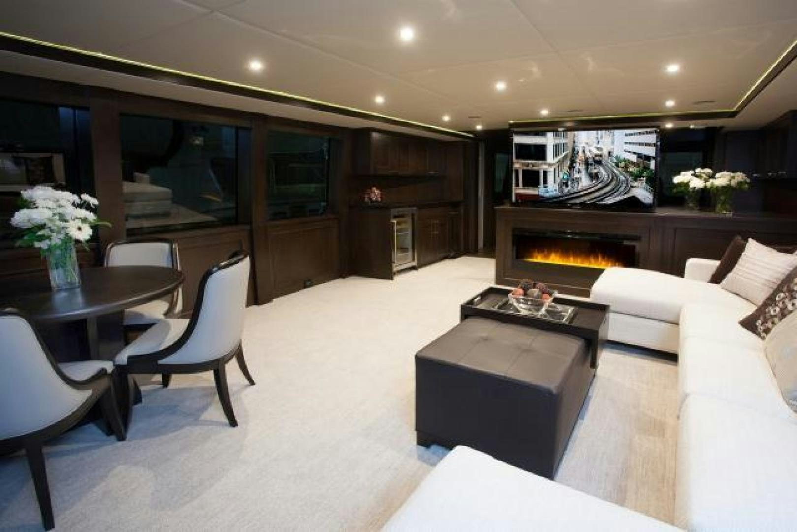 a living room with a fireplace aboard ENCORE Yacht for Sale