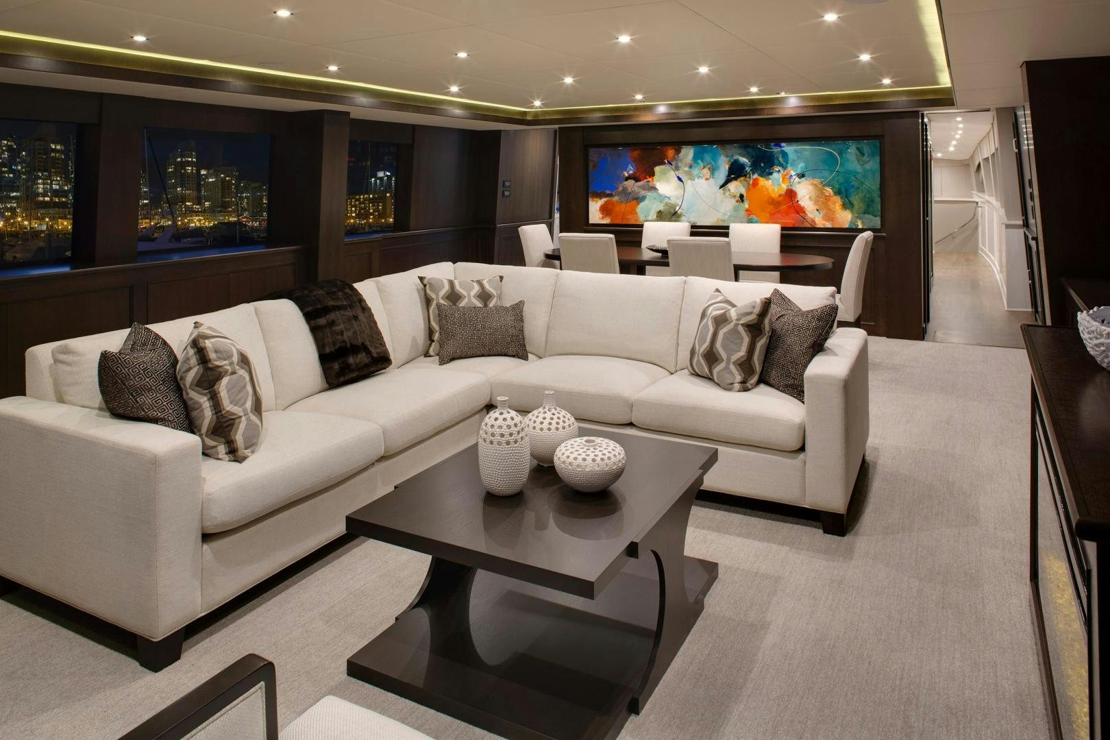 a living room with a white couch and a table aboard ENCORE Yacht for Sale