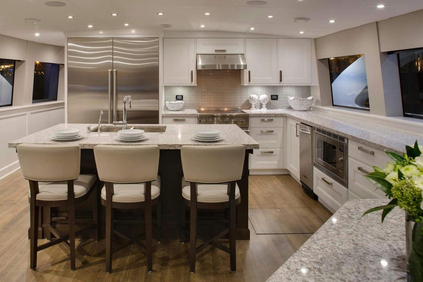 a kitchen with white cabinets aboard ENCORE Yacht for Sale