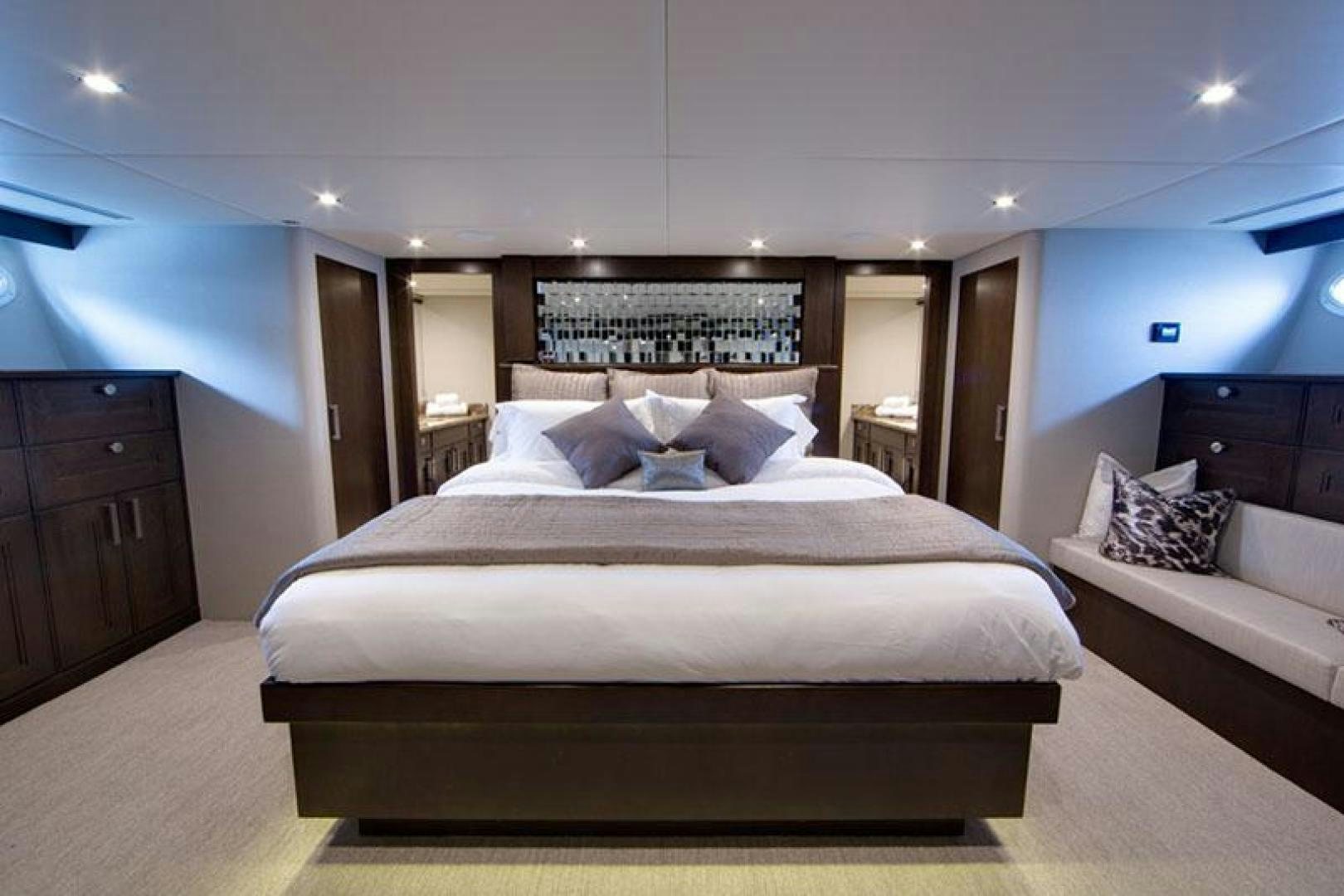 a large bed in a hotel room aboard ENCORE Yacht for Sale