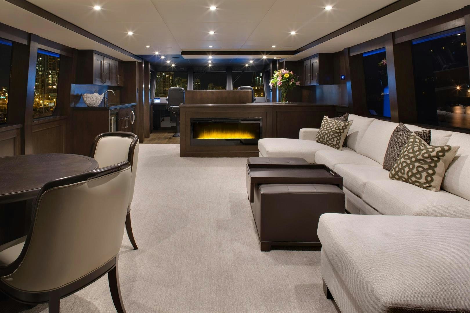 a living room with a fireplace aboard ENCORE Yacht for Sale
