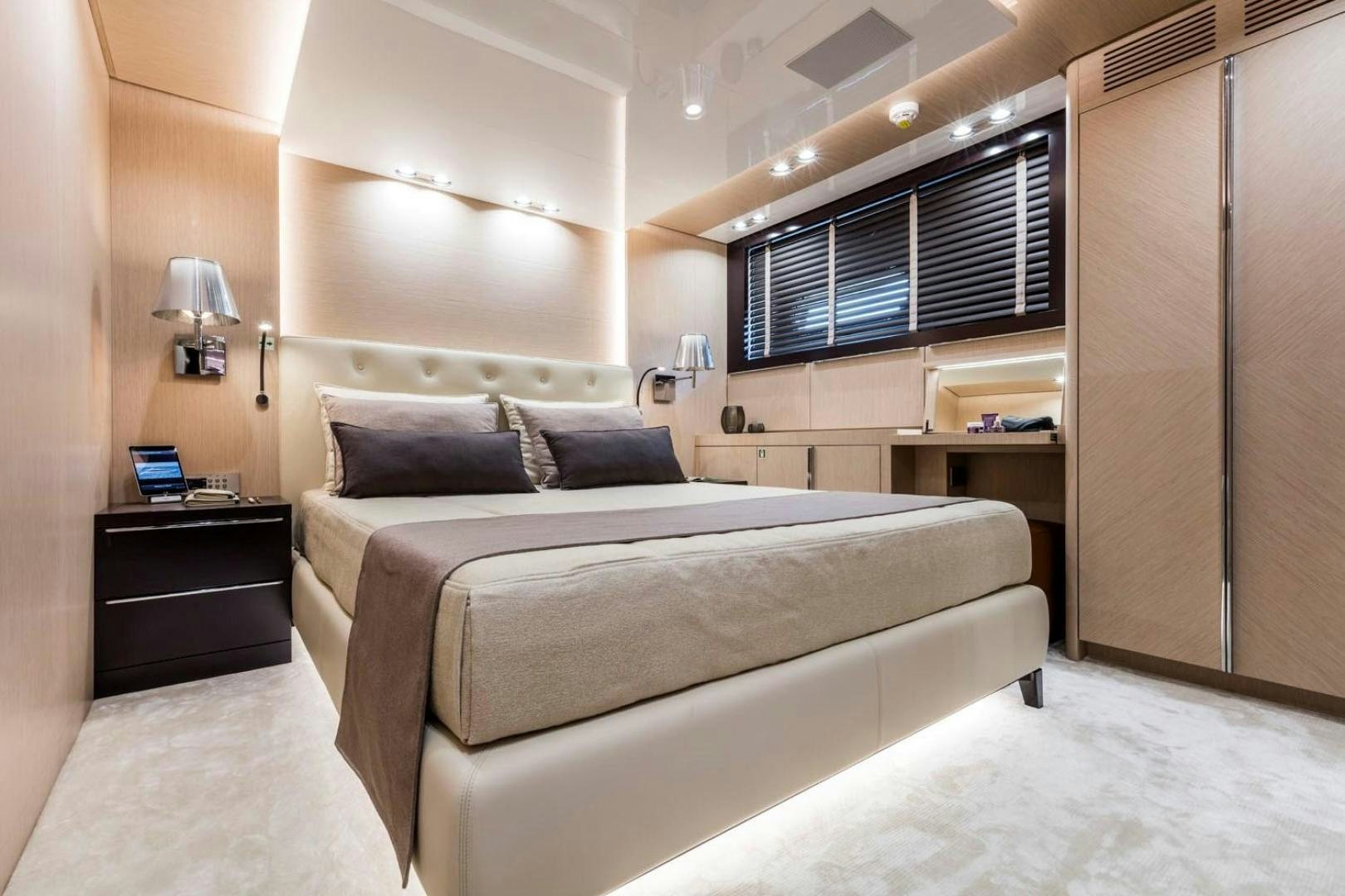 a bedroom with a bed and desk aboard CLORINDA Yacht for Sale