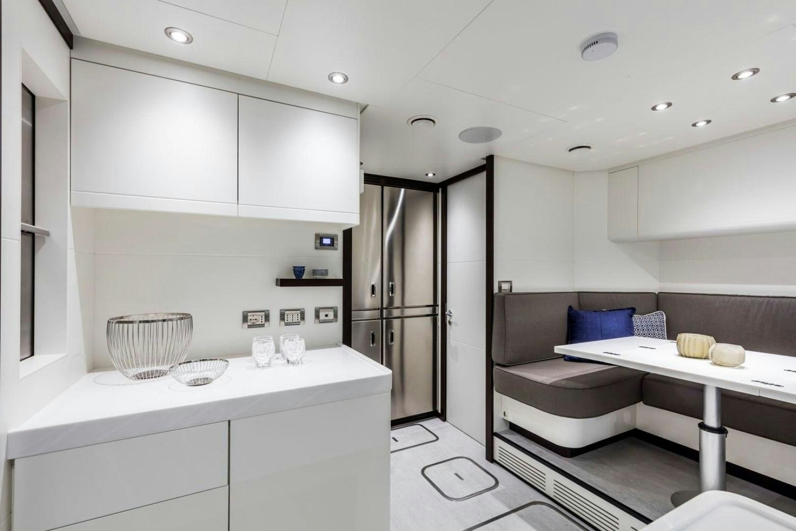 a white kitchen with a white counter aboard CLORINDA Yacht for Sale