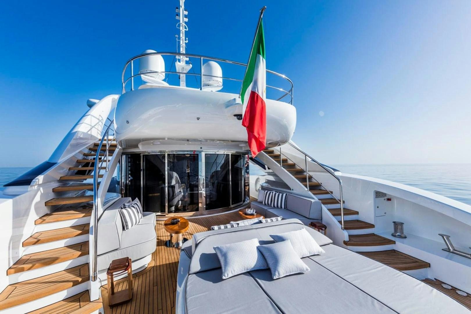a boat with a flag on the deck aboard CLORINDA Yacht for Sale