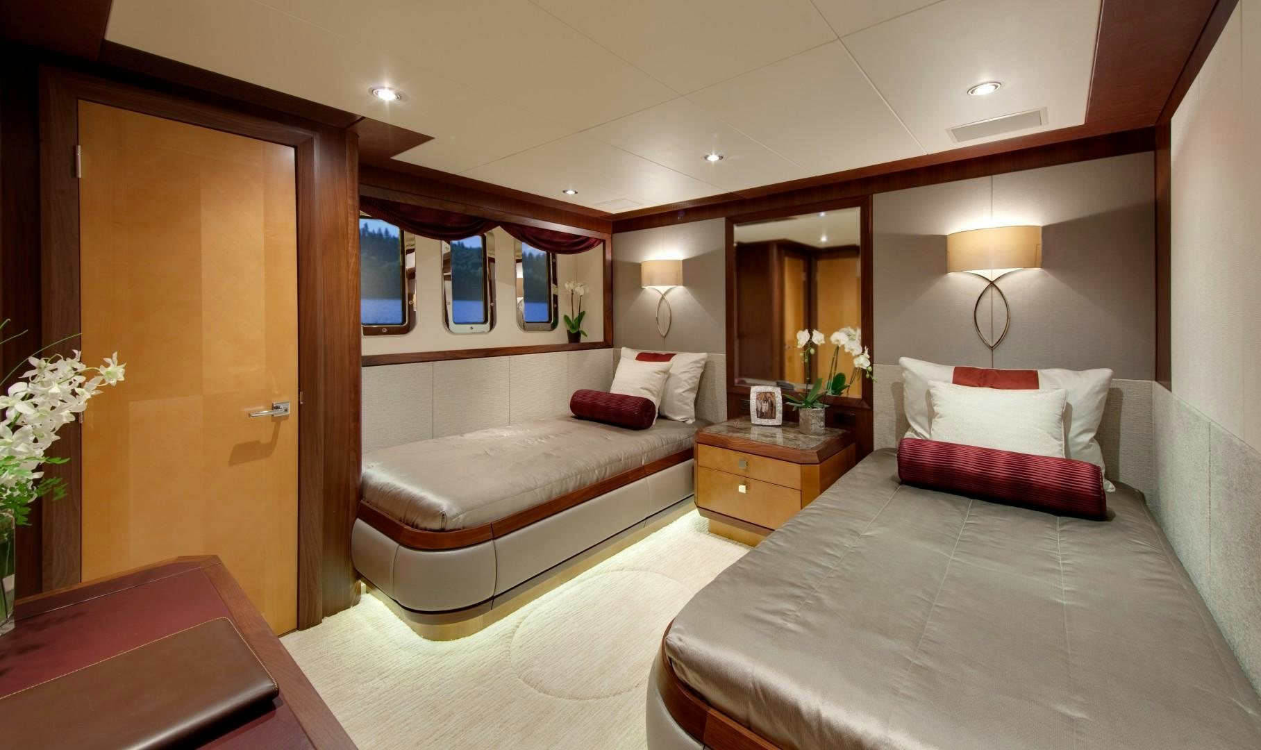 a hotel room with a bed and a desk aboard DREAM WEAVER Yacht for Sale