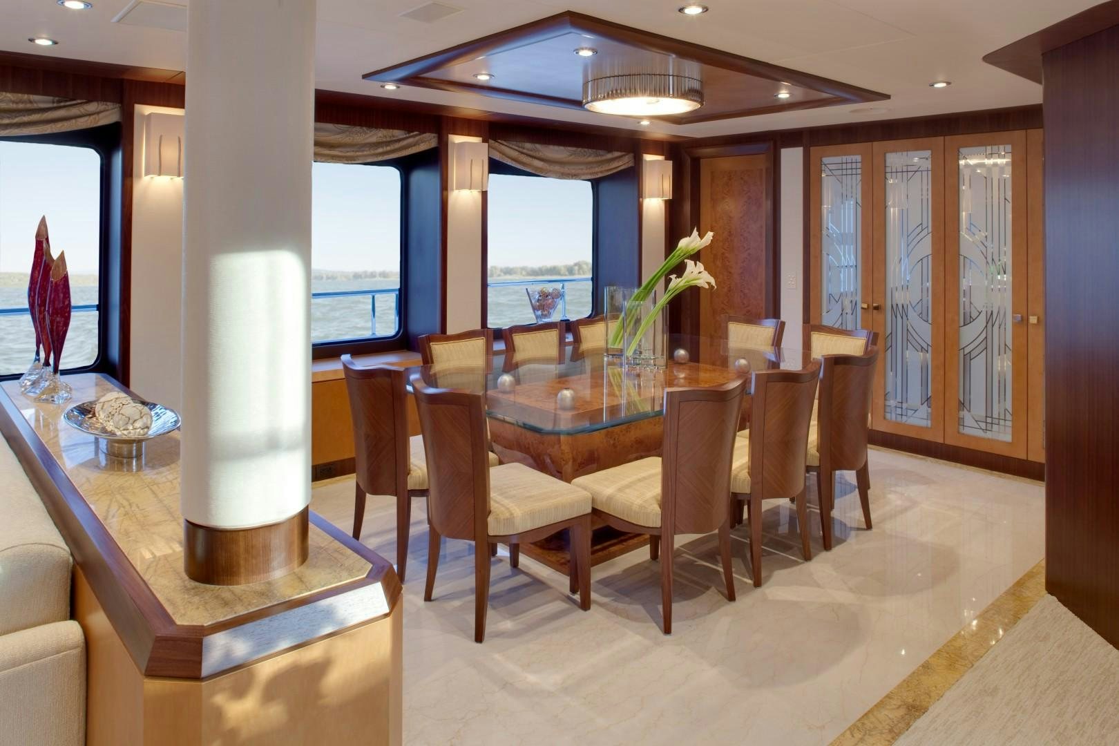 a dining room with a table and chairs aboard DREAM WEAVER Yacht for Sale