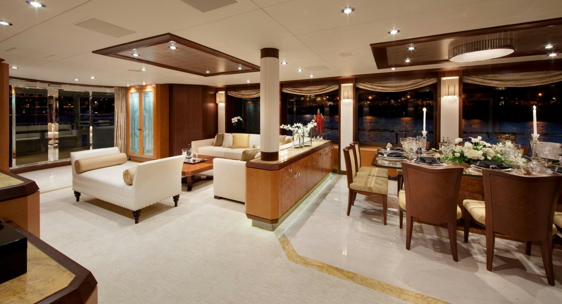 a large living room with a large table and chairs aboard DREAM WEAVER Yacht for Sale