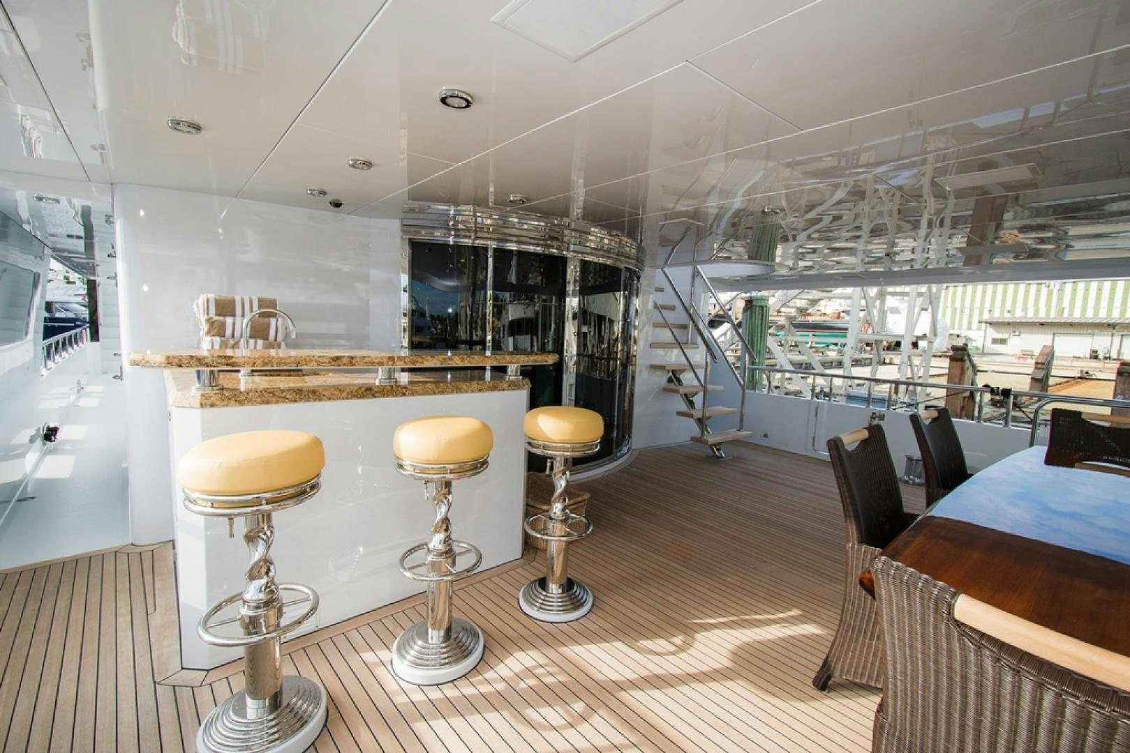 a room with stools and tables aboard DREAM WEAVER Yacht for Sale