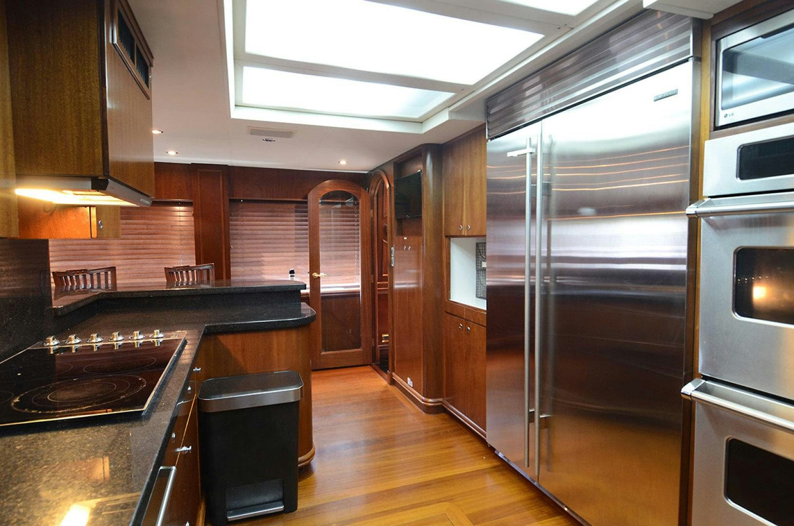 a kitchen with wooden cabinets aboard OCEAN CLUB Yacht for Sale