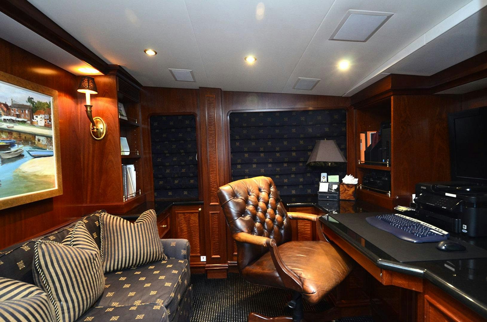 a living room with a desk and a computer aboard OCEAN CLUB Yacht for Sale
