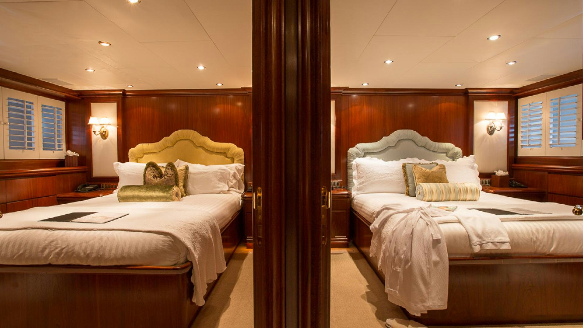 a room with two beds aboard OCEAN CLUB Yacht for Sale
