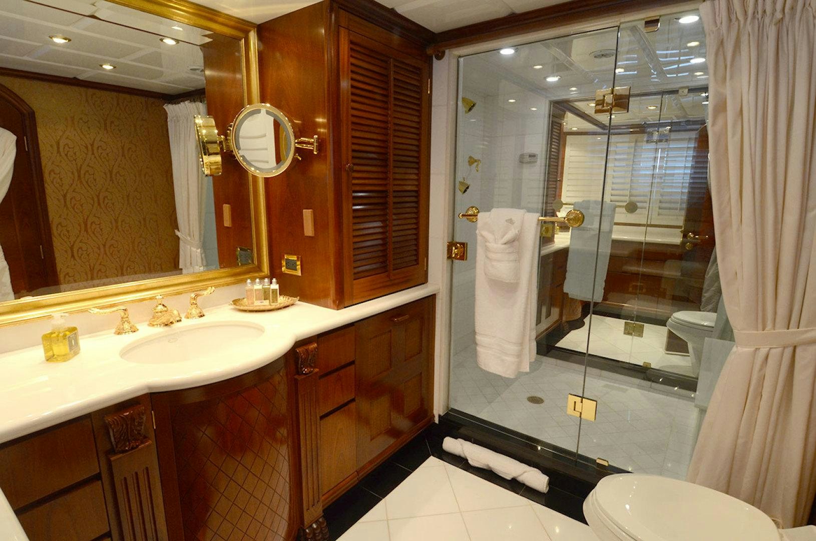 a bathroom with a glass shower aboard OCEAN CLUB Yacht for Sale