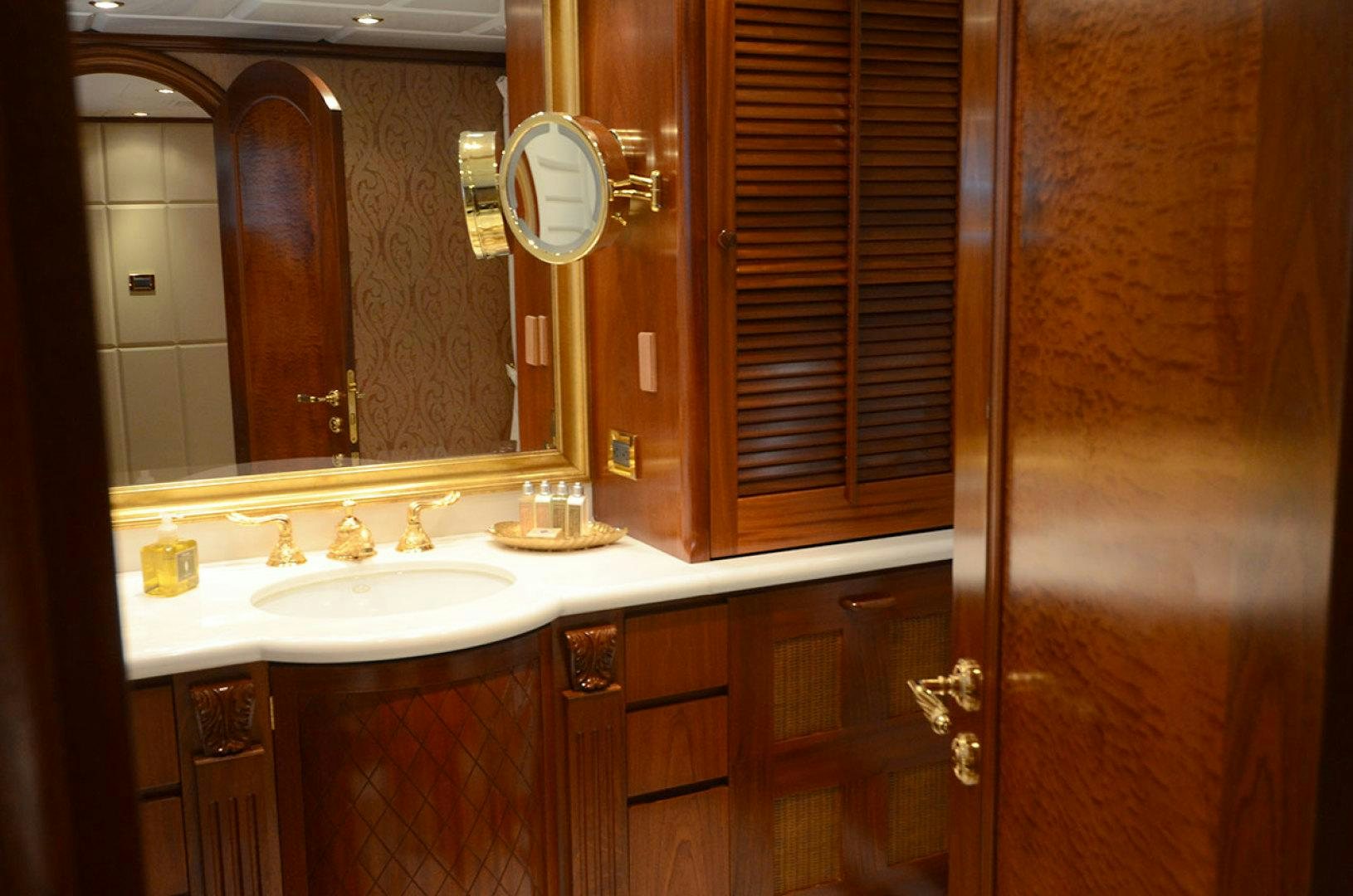 a bathroom with a mirror and a sink aboard OCEAN CLUB Yacht for Sale