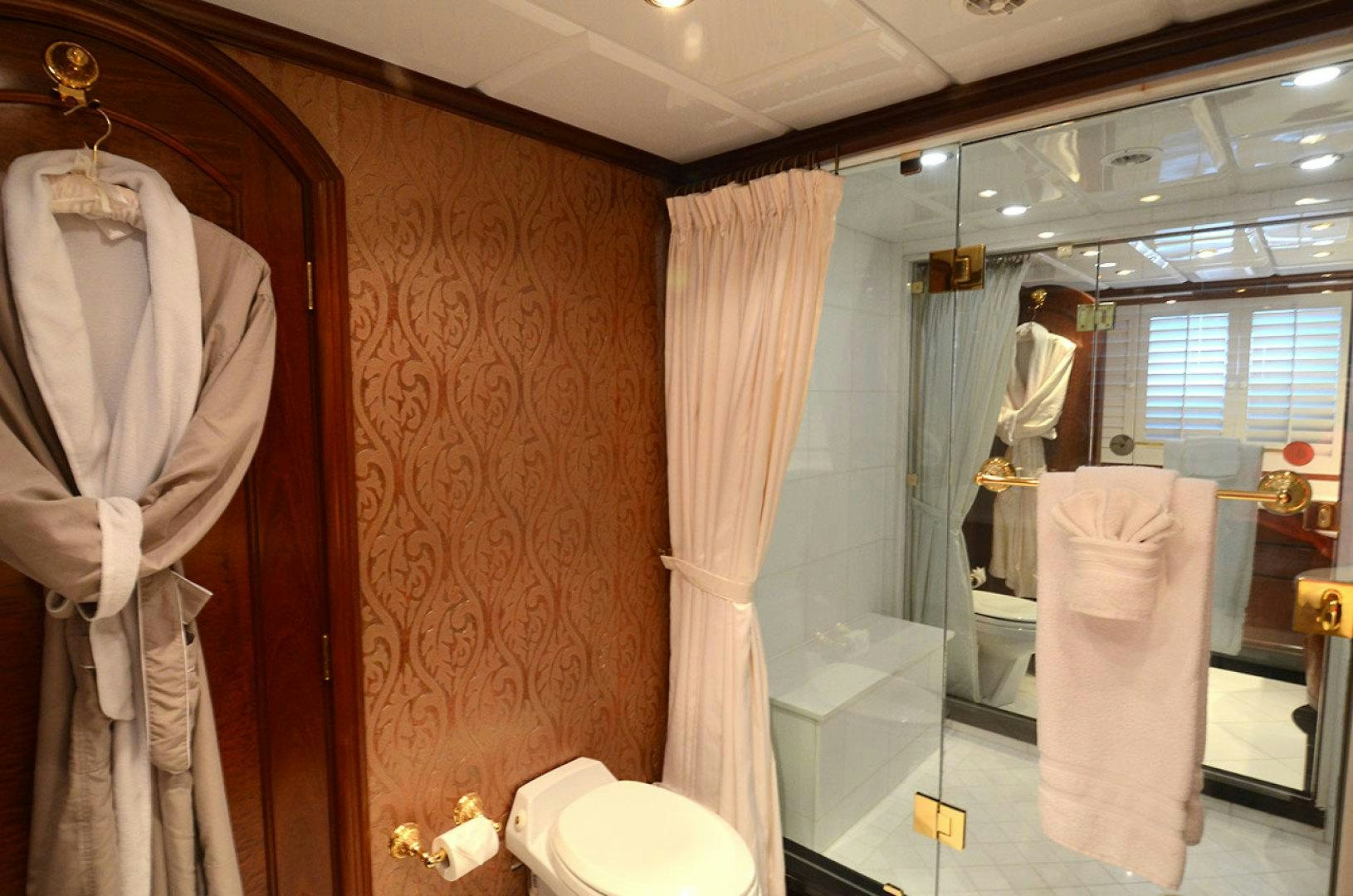 a bathroom with a glass shower aboard OCEAN CLUB Yacht for Sale
