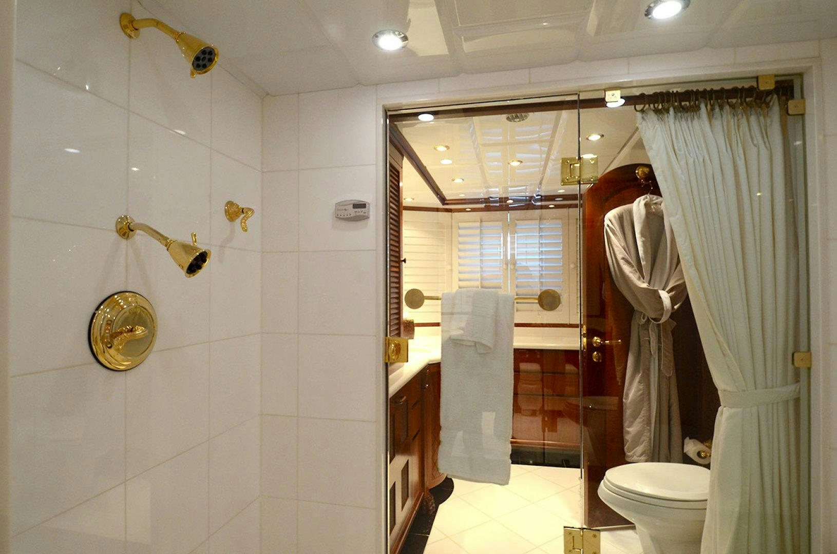 a bathroom with a shower and toilet aboard OCEAN CLUB Yacht for Sale