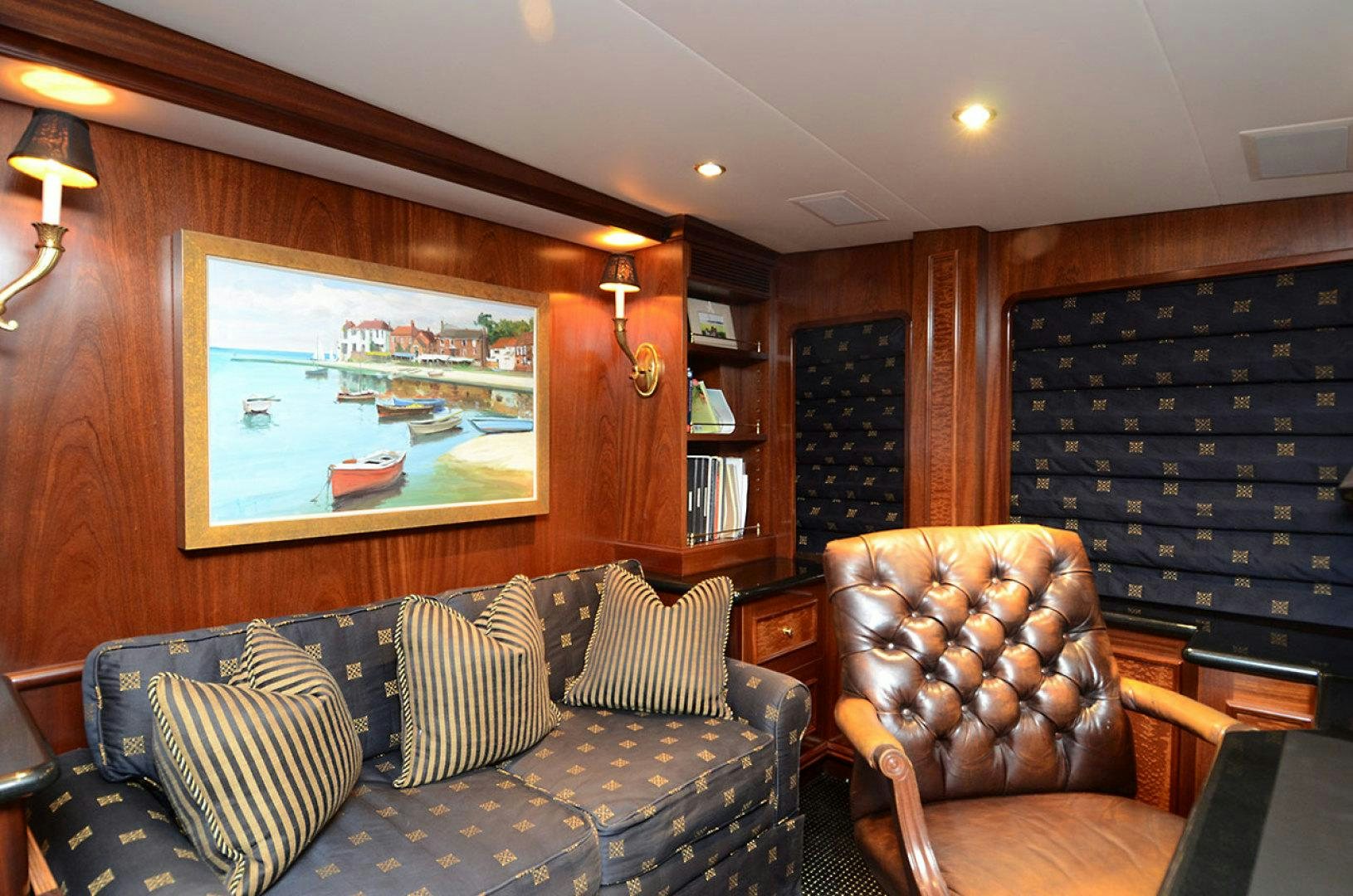 a living room with a large screen aboard OCEAN CLUB Yacht for Sale