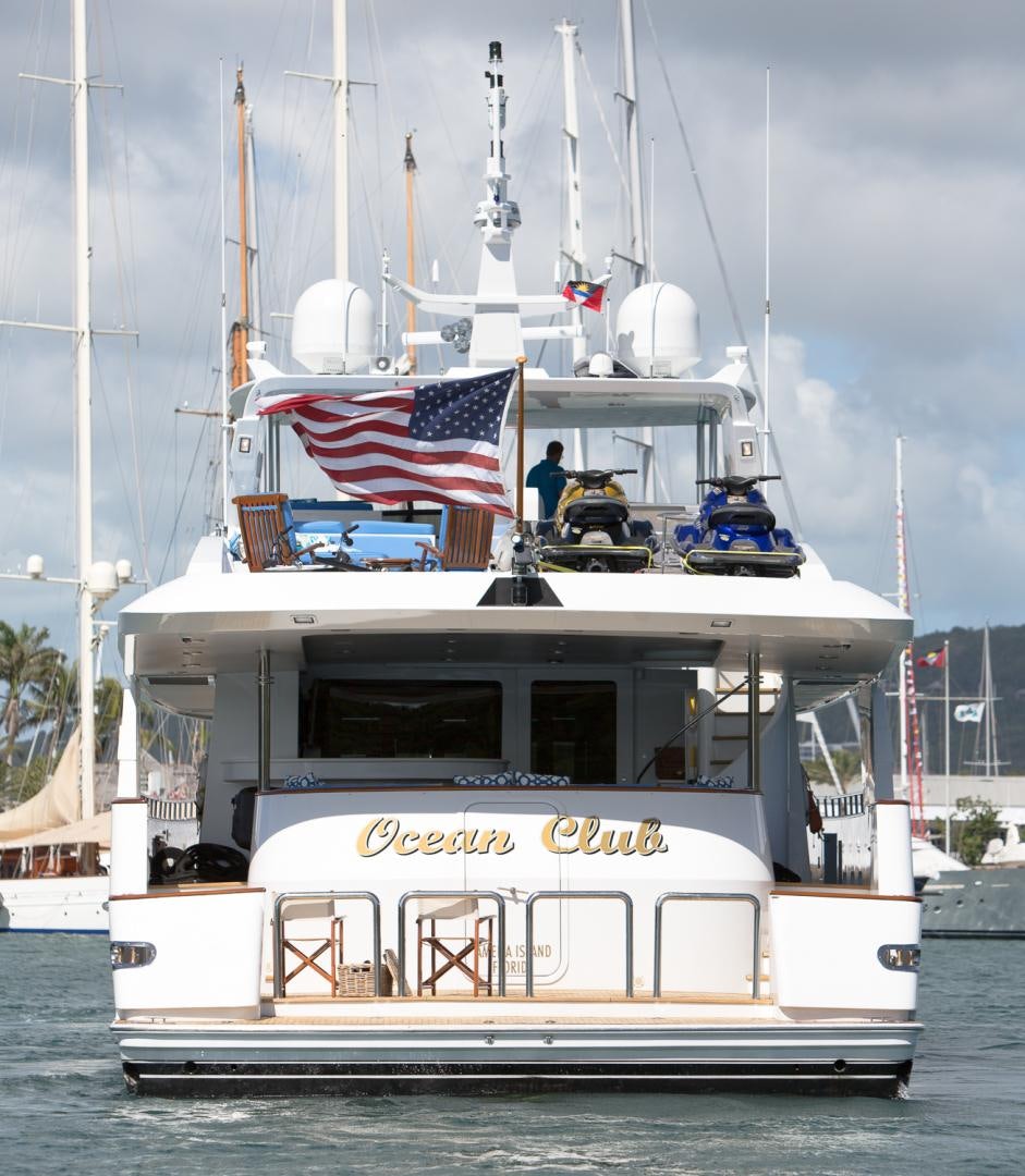 a boat with a flag on the front aboard OCEAN CLUB Yacht for Sale