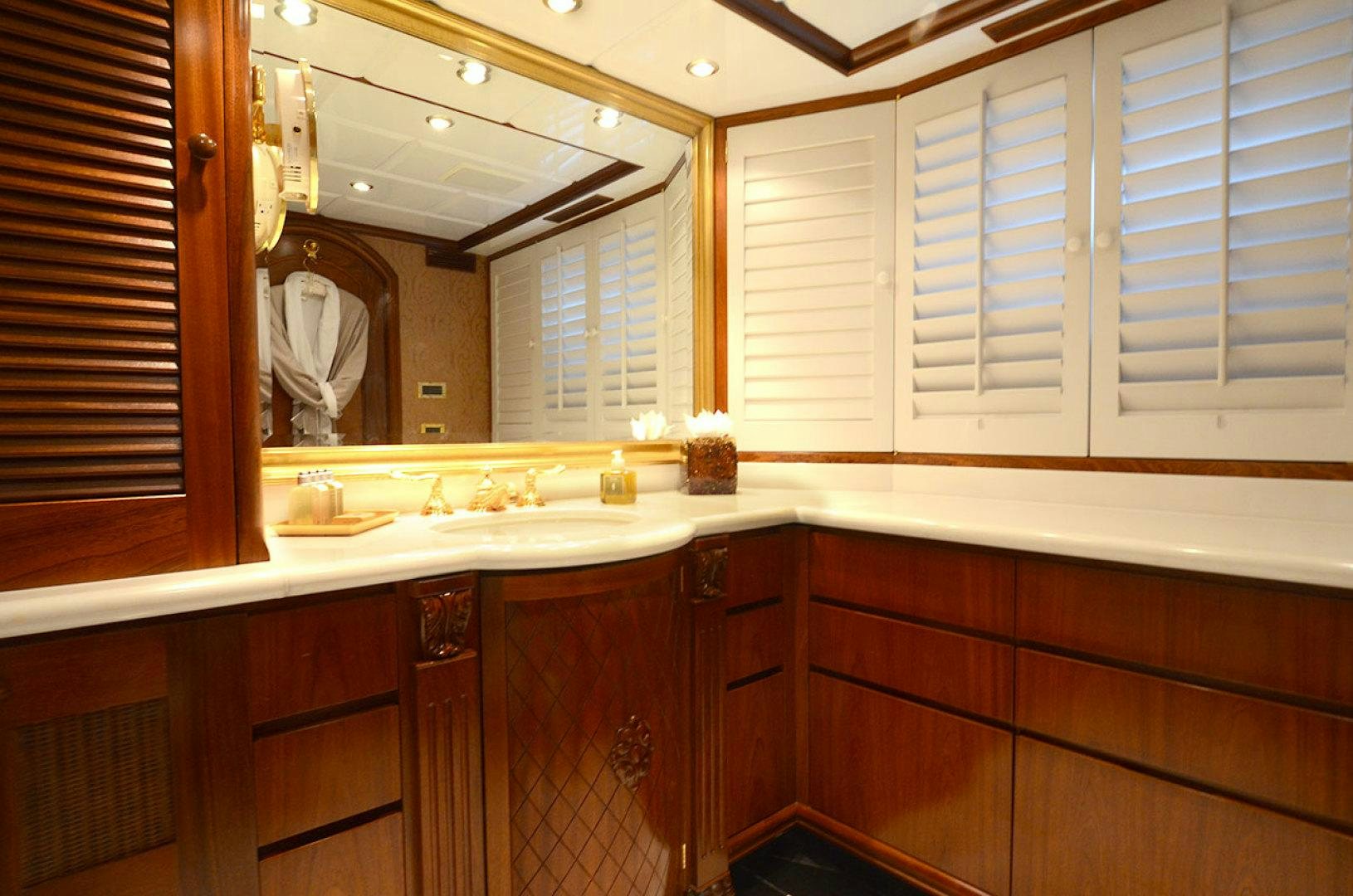 a bathroom with white cabinets aboard OCEAN CLUB Yacht for Sale