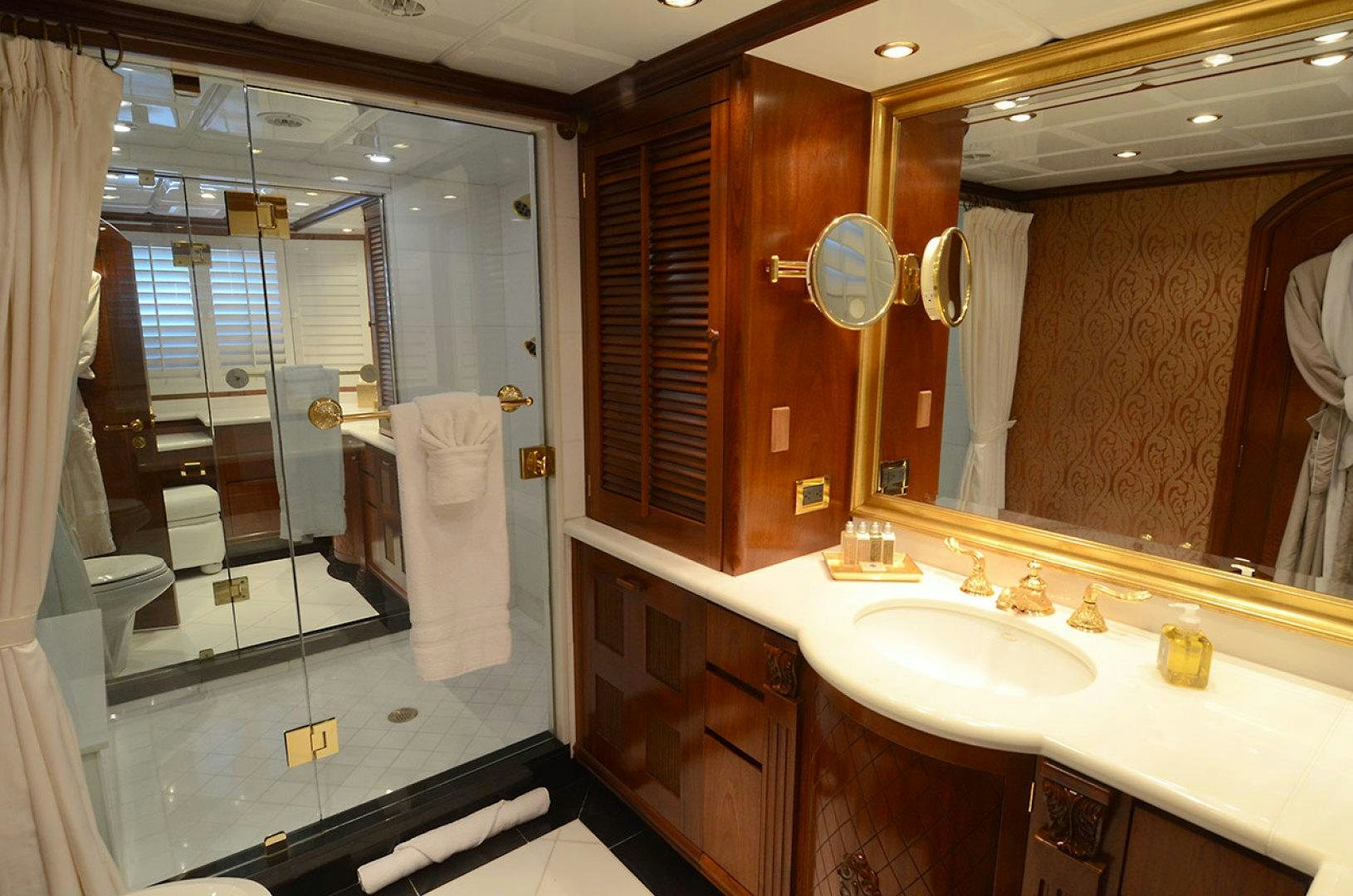 a bathroom with a large mirror aboard OCEAN CLUB Yacht for Sale