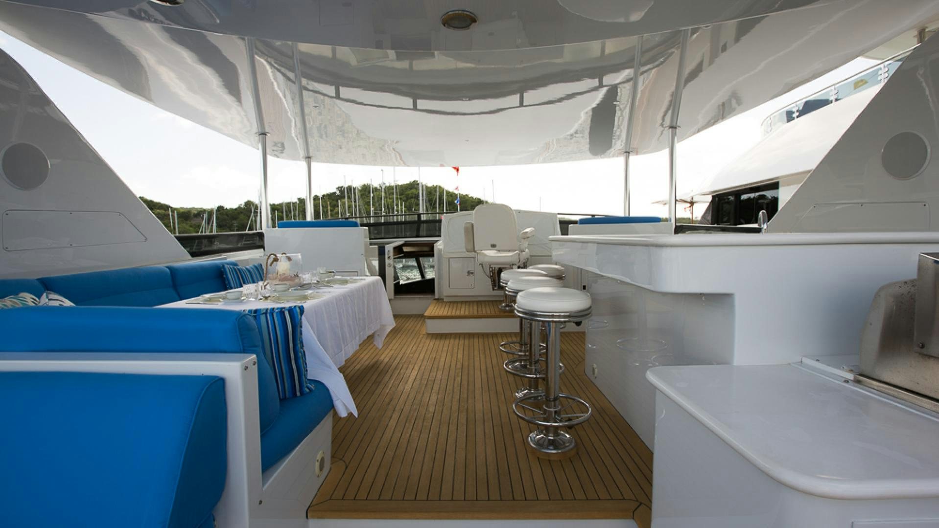 a room with a table chairs and a large window aboard OCEAN CLUB Yacht for Sale