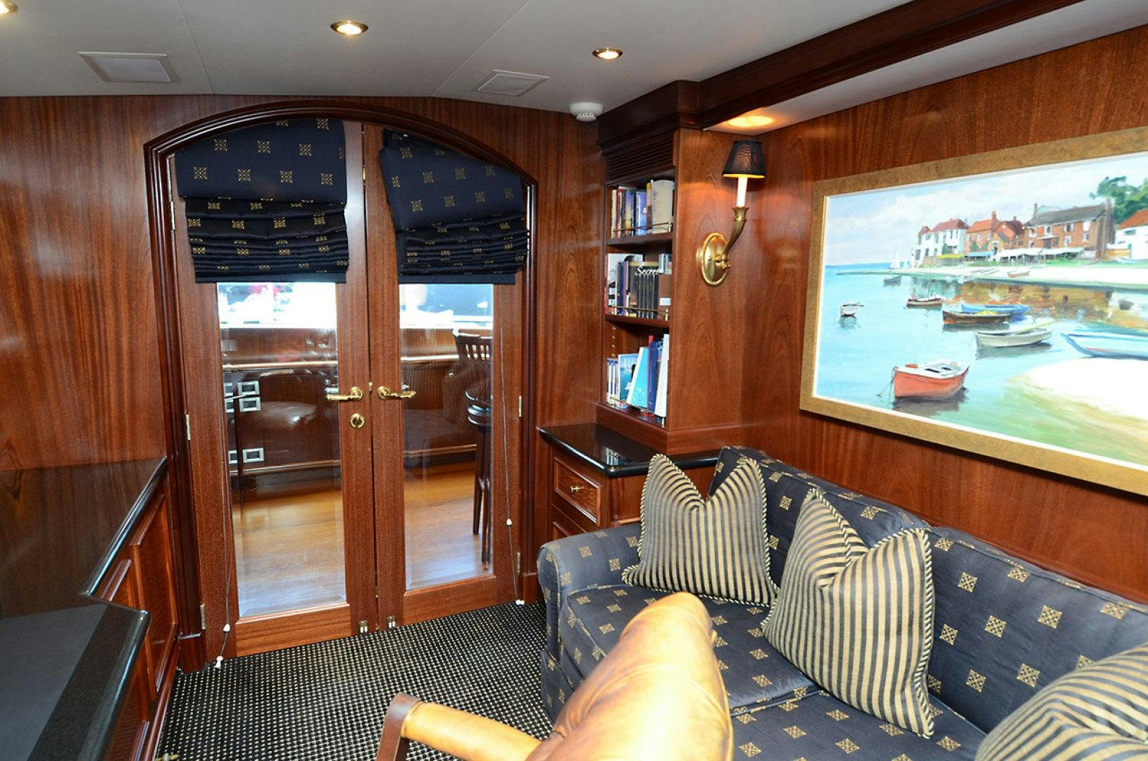 a living room with a large glass door aboard OCEAN CLUB Yacht for Sale