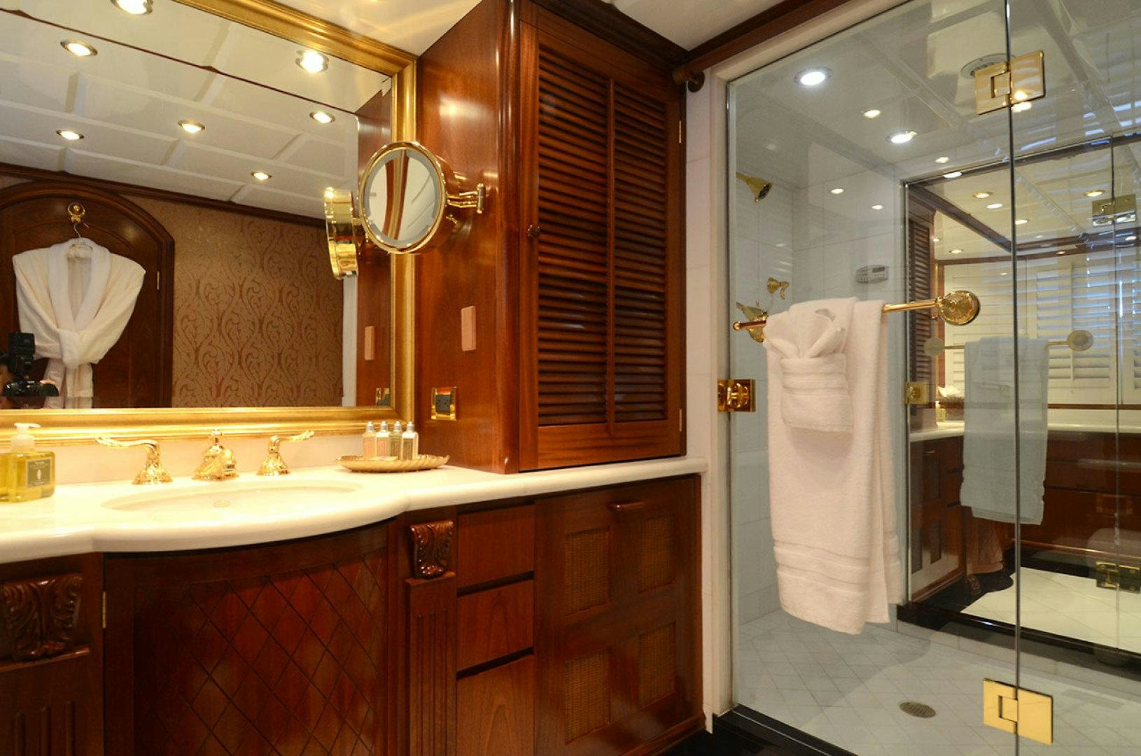 a bathroom with a shower and sink aboard OCEAN CLUB Yacht for Sale