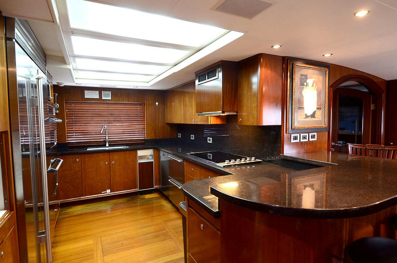 a kitchen with wooden cabinets aboard OCEAN CLUB Yacht for Sale