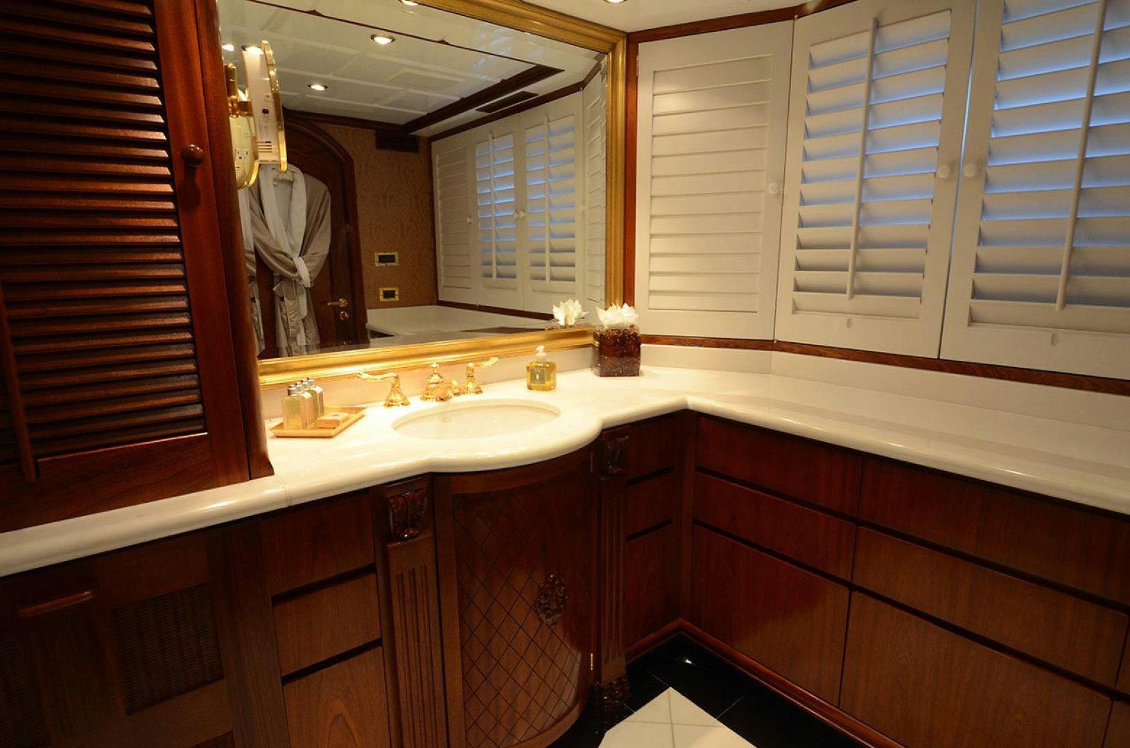 a bathroom with a large mirror aboard OCEAN CLUB Yacht for Sale