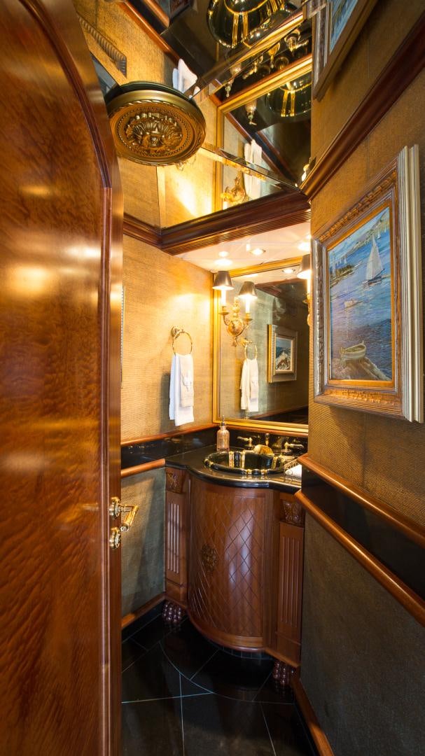 a bathroom with a sink and a mirror aboard OCEAN CLUB Yacht for Sale