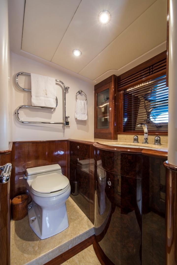 a bathroom with a toilet and a sink aboard SOVEREIGN Yacht for Sale