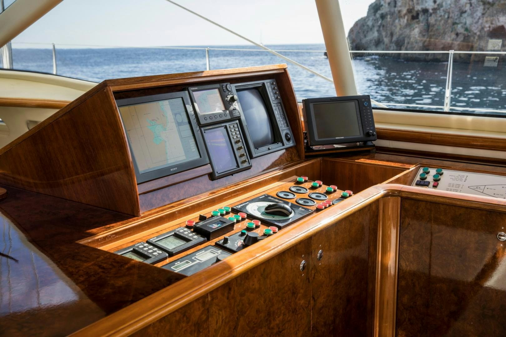 a table with a television and a couple of tvs on it aboard SOVEREIGN Yacht for Sale
